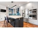 Modern kitchen with stainless steel appliances, kitchen island, and sleek cabinets at 2334 Lowell Blvd, Denver, CO 80211