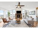 Bright and airy living room with vaulted ceilings, fireplace, and expansive mountain views at 31969 Robinson Hill Rd, Golden, CO 80403