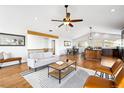 Open-concept living room and dining area with hardwood floors and natural light at 31969 Robinson Hill Rd, Golden, CO 80403