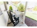 Relaxing front porch featuring classic rocking chairs and a peaceful neighborhood view at 4172 Deer Watch Dr, Castle Rock, CO 80104