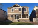 The backyard features tan siding, a concrete patio, and a grassy area for outdoor enjoyment at 4995 S Algonquian Way, Aurora, CO 80016