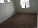 Cozy bedroom with a neutral color scheme, plush carpet, natural light from the window, and ample space at 4995 S Algonquian Way, Aurora, CO 80016