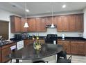 Spacious kitchen featuring wood cabinets, granite countertops, and stainless steel appliances at 4995 S Algonquian Way, Aurora, CO 80016