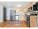 Bright and spacious kitchen with stainless steel appliances and light wood cabinets at 33 N Corona St # 404, Denver, CO 80218