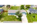 Aerial shot of the home showing the well-maintained lawn, fenced backyard, and neighborhood at 1853 Burton St, Strasburg, CO 80136