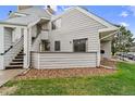 Gray siding and a small patio area accent this condominium at 17004 E Tennessee Dr # 103, Aurora, CO 80017
