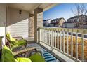 Relaxing front porch with wicker furniture and view of neighborhood at 21837 E Stanford Cir, Aurora, CO 80015