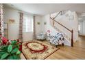 Bright living room with hardwood floors, comfortable seating, and a staircase at 21837 E Stanford Cir, Aurora, CO 80015