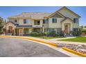 Inviting townhome exterior with lush greenery and a well-manicured lawn under a clear blue sky at 22560 E Ontario Dr # 204, Aurora, CO 80016