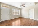 Bright living room with hardwood floors, a ceiling fan, and an abundance of natural light at 3760 Ute Mountain Trl, Castle Rock, CO 80109