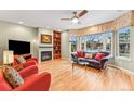 Inviting living room featuring a fireplace, built-in bookcase, and a large bay window at 1131 Elizabeth St, Denver, CO 80206
