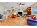 Bright living room with hardwood floors, fireplace, and staircase to the second floor at 1131 Elizabeth St, Denver, CO 80206