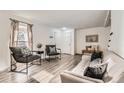 Bright and airy living room with modern furniture, neutral tones, and hardwood floors at 5155 E 108Th Pl, Thornton, CO 80233