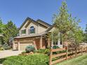 Two-story home displaying landscaped front yard and a partial view of the brick and siding exterior at 6366 Umber Cir, Arvada, CO 80403