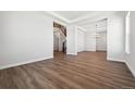 Open-concept living room with wood floors, recessed lighting, and a view of the staircase and dining area at 4949 Hickory Oaks St, Castle Rock, CO 80104