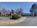 Wide angle shot of Steeplechase II community sign with a paved sidewalk bordering the curb at 3030 W Prentice Ave # G, Littleton, CO 80123