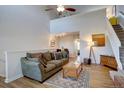 Inviting living room featuring vaulted ceilings, wood floors, and an open layout to the kitchen at 3030 W Prentice Ave # G, Littleton, CO 80123