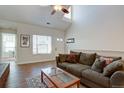 Comfortable living room with a large couch, vaulted ceiling, and bright window light at 3030 W Prentice Ave # G, Littleton, CO 80123