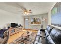 Inviting living room with natural light, hardwood floors, and a comfortable seating area with large window at 8057 Lafayette St, Denver, CO 80229