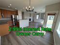 Spacious open-concept living area with a kitchen, fireplace, modern lighting, and hardwood flooring at 13013 Grant Cir # C, Thornton, CO 80241