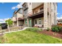 Beautiful front porch with cozy seating, well-kept lawn, and inviting green door at 5668 Galena St, Denver, CO 80238