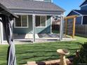 Serene backyard featuring well-maintained lawn, partially covered patio, and great privacy at 9011 Sandpiper Dr, Longmont, CO 80504