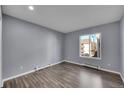 Bedroom with a large window and wood-look flooring, with neutral paint at 4064 S Atchison Way # 204, Aurora, CO 80014