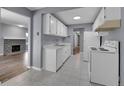 Functional kitchen with white cabinetry, tile flooring, and modern appliances, next to a dining area at 4064 S Atchison Way # 204, Aurora, CO 80014