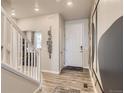 Bright entryway with hardwood floors and modern light fixture at 1465 Bloom St, Brighton, CO 80601