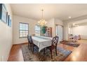 Formal dining room featuring hardwood floors, chandelier, and seating for six at 7562 E 130Th Cir, Thornton, CO 80602