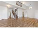 Bright and airy living room with hardwood floors, high ceilings, and staircase at 7944 E Lowry Blvd, Denver, CO 80230