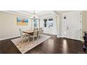 Elegant dining room with hardwood floors, chandelier, and a large window at 20223 Terrace View Dr, Parker, CO 80134