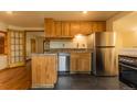 An efficient kitchen with stainless appliances, granite countertops, and wood cabinets at 4850 Forest Hill Rd, Evergreen, CO 80439