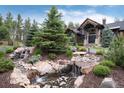 Beautiful landscaping with a waterfall feature welcomes you to this exceptional home at 44 N Big Meadow Trl, Franktown, CO 80116