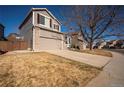 Inviting home with a two-car garage and a concrete driveway, complemented by a lush lawn at 4927 Tarcoola Ln, Highlands Ranch, CO 80130