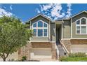 Charming townhouse featuring stone accents, an attached garage and mature landscaping at 6821 W Yale Ave, Lakewood, CO 80227