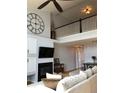 Cozy living room with a fireplace, open to the upper level, creating a bright and airy atmosphere at 6821 W Yale Ave, Lakewood, CO 80227