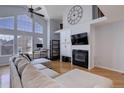 Spacious living room featuring a fireplace, large windows, and an open layout perfect for entertaining at 6821 W Yale Ave, Lakewood, CO 80227