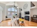 Bright living room with large windows, vaulted ceilings, and a cozy fireplace at 6821 W Yale Ave, Lakewood, CO 80227