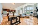 Open-concept living space with dining area, kitchen, and plenty of natural light at 6821 W Yale Ave, Lakewood, CO 80227
