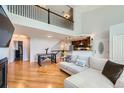 Inviting living space with hardwood floors, comfortable seating, and a view of the upstairs at 6821 W Yale Ave, Lakewood, CO 80227