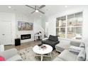 Bright living room with stylish furnishings, a fireplace with TV above, and large windows for natural light at 8376 Lorenzo Ln # A, Highlands Ranch, CO 80129