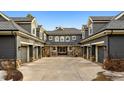 Rear exterior showcasing garages and a stone and gray shingle design at 4301 S Lafayette St, Cherry Hills Village, CO 80113