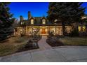 Charming stone front exterior featuring a stone walkway and covered porch with stately columns at 4301 S Lafayette St, Cherry Hills Village, CO 80113