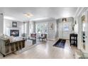 Open living space with a fireplace, stylish decor, and an entryway with a decorative door at 1250 S Vine St, Denver, CO 80210