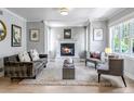Bright living room featuring a fireplace, neutral decor, and large windows at 1250 S Vine St, Denver, CO 80210