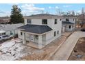 Two story house, gray siding, dark roof, small front porch, and driveway at 3224 W Dakota Ave, Denver, CO 80219