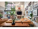 A cozy living room with leather furniture, plants and an assortment of wall art at 930 Acoma St # 106, Denver, CO 80204