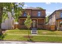 Attractive brick home with a covered front porch and fresh landscaping at 2515 N Gaylord St, Denver, CO 80205