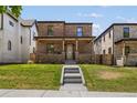 Inviting brick home with a classic design and a well-maintained green lawn at 2515 N Gaylord St, Denver, CO 80205